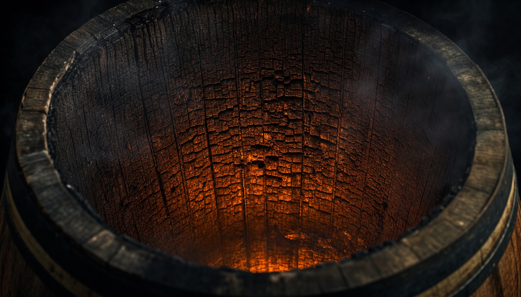 Extreme close-up looking into a freshly charred American white oak bourbon barrel, deep cracked alligator char glowing with amber firelight